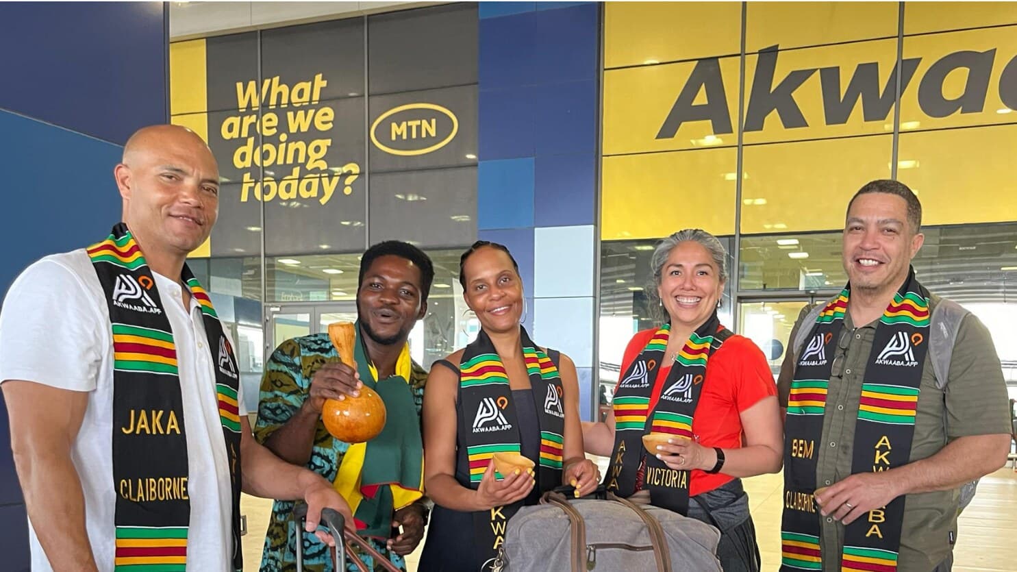 A diaspora family arriving at Kotoka airport in Ghana, welcomed with personalised Akwaaba kente stoles